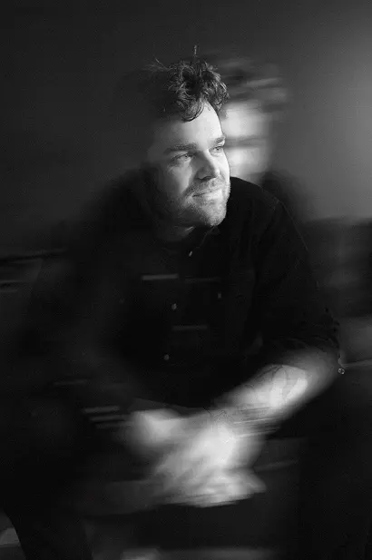 Black and white portrait of director Morgan Grunefeld